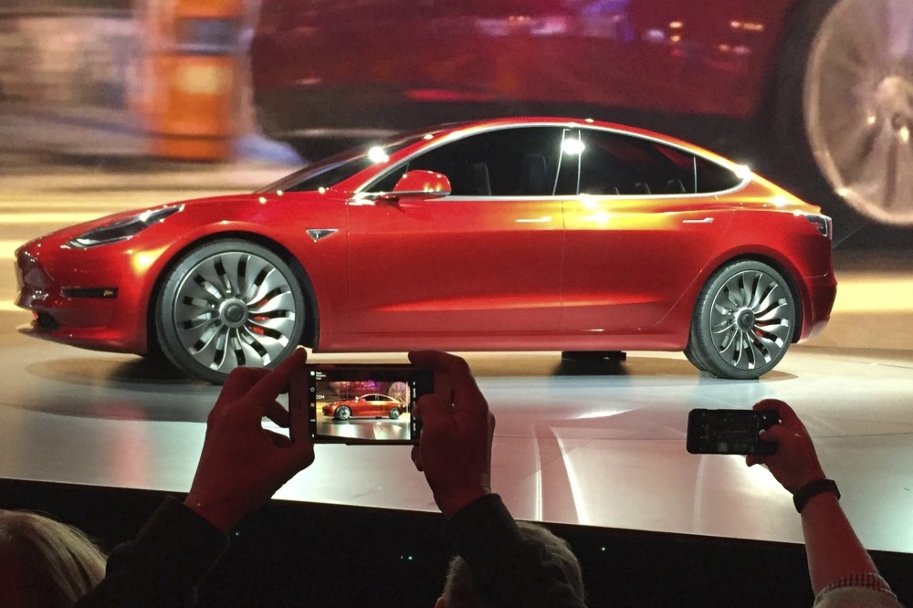 In this March 31, 2016, file photo, Tesla Motors unveiled the new lower-priced Model 3 sedan at the Tesla Motors design studio in Hawthorne, Cal.