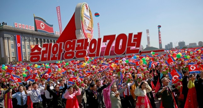 North Korea holds back missiles, puts economy first in parade to mark