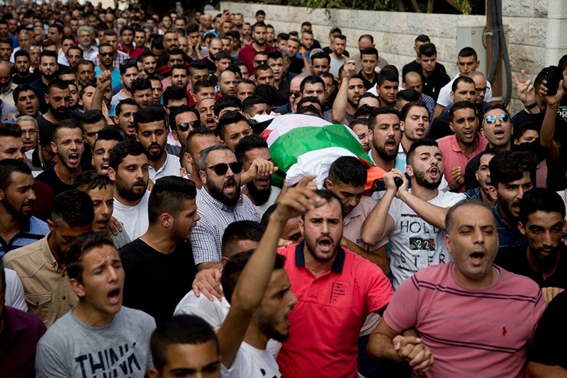 Palestinians carry the body of Aisha Mohammed Rabi during her funeral in the West Bank village of Biddya on Oct. 13. (Majdi Mohammed/AP)