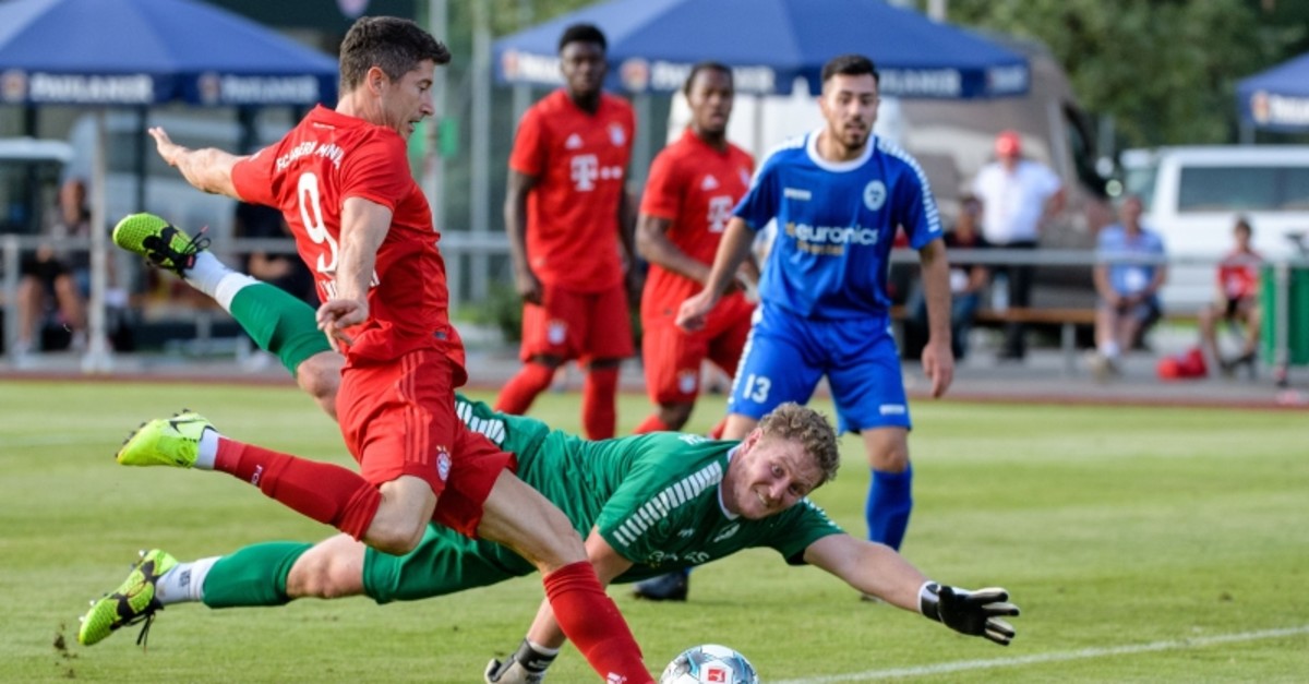 Bayern Munich's Polish forward Robert Lewandowski scores past Rottach-Eger's goalkeeper Domingo Grafunder during the prs-season friendly football match between FC Rottach-Eger and FC Bayern Munich in Rottach-Eger, southern Germany on August 8, 2019.