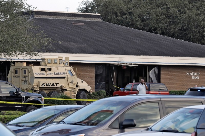 A Highlands County Sheriff's SWAT vehicle is stationed out in front of a SunTrust Bank branch, Wednesday, Jan. 23, 2019, in Sebring, Fla., where authorities say five people were shot and killed. (AP Photo)