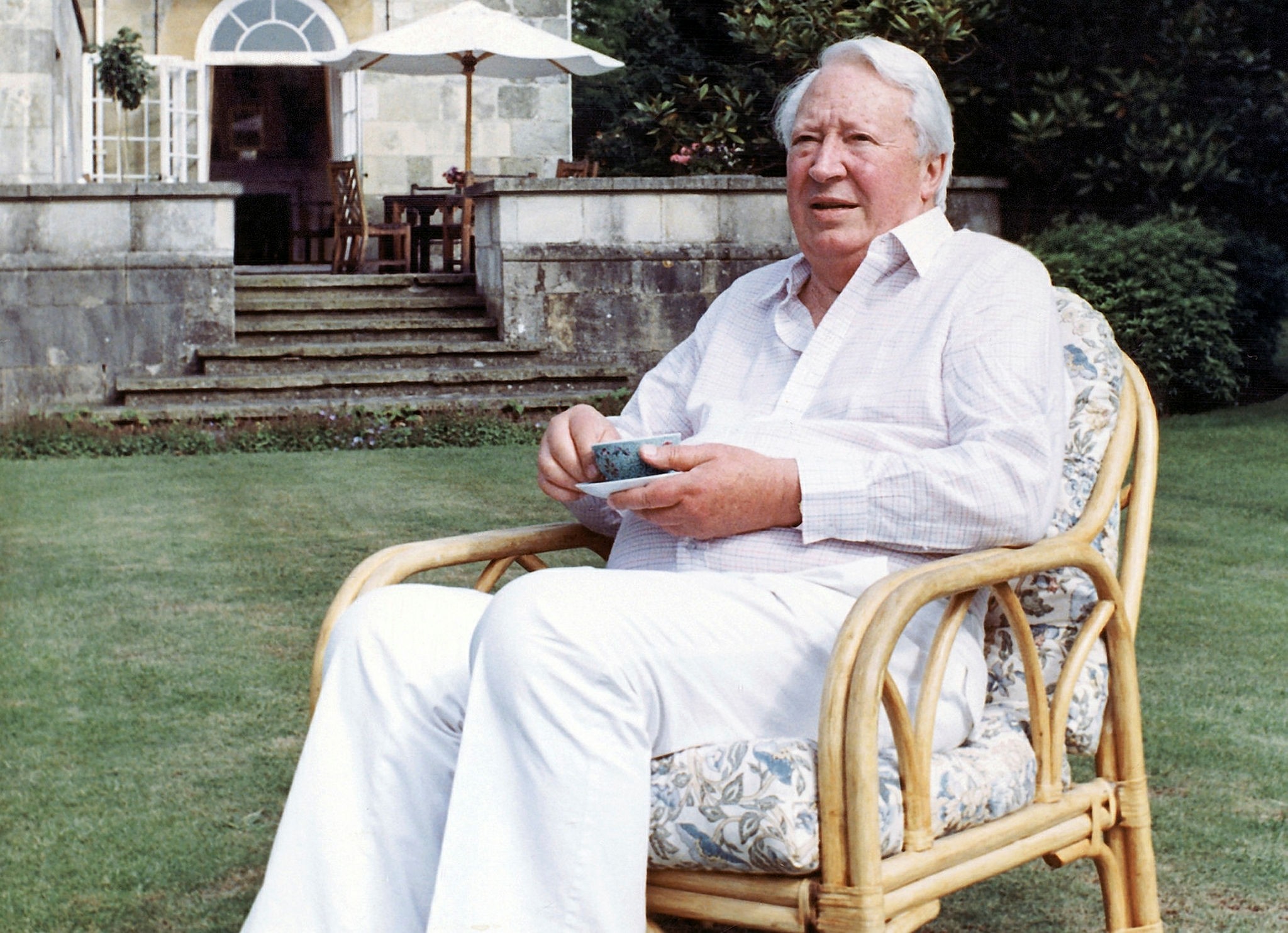 This is a July 19, 1989 file photo of former British Prime Minister Edward Heath as he takes tea in the garden of his home in Salisbury, England. (AP Photo)