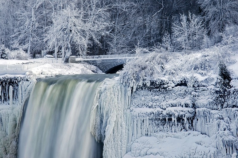 Almost every year frigid temperatures transform Niagara Falls State Park into an icy winter wonderland when the mist of the falls is blown back, freezing on the landscape.