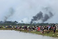 Smoke billows above what is believed to be a burning village in Myanmar's Rakhine state as members of the Rohingya Muslim minority take shelter in a no-man's land between Bangladesh and Myanmar (AFP Photo)