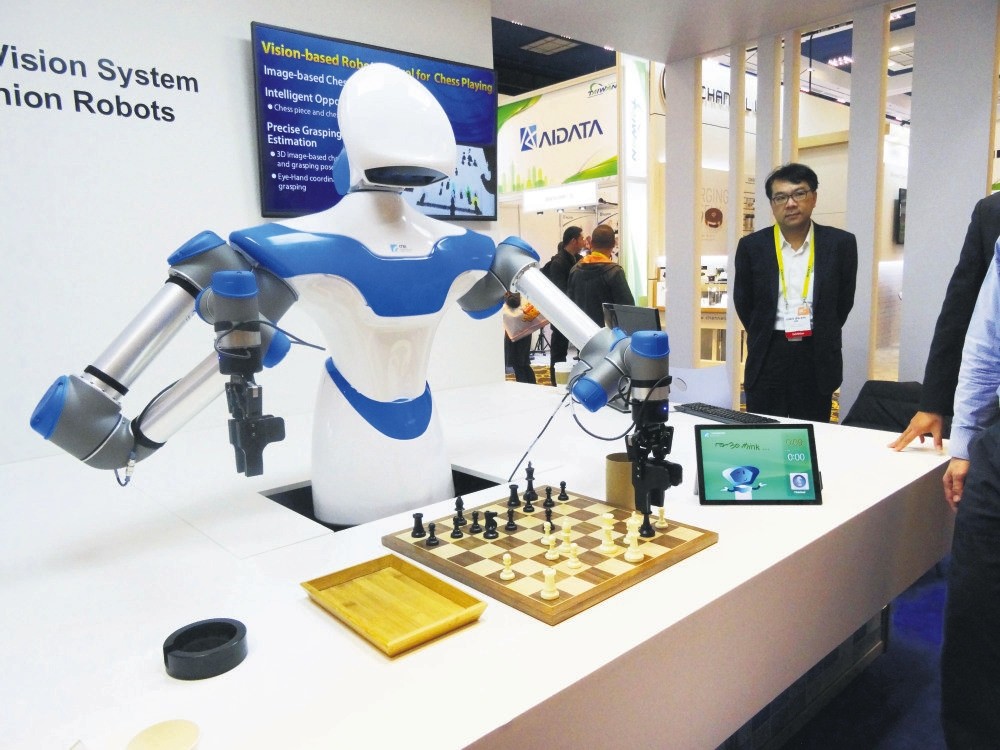 A robot developed by Taiwan engineers moves chess pieces on a board against an opponent at the 2017 Consumer Electronic Show in Las Vegas, Nevada.