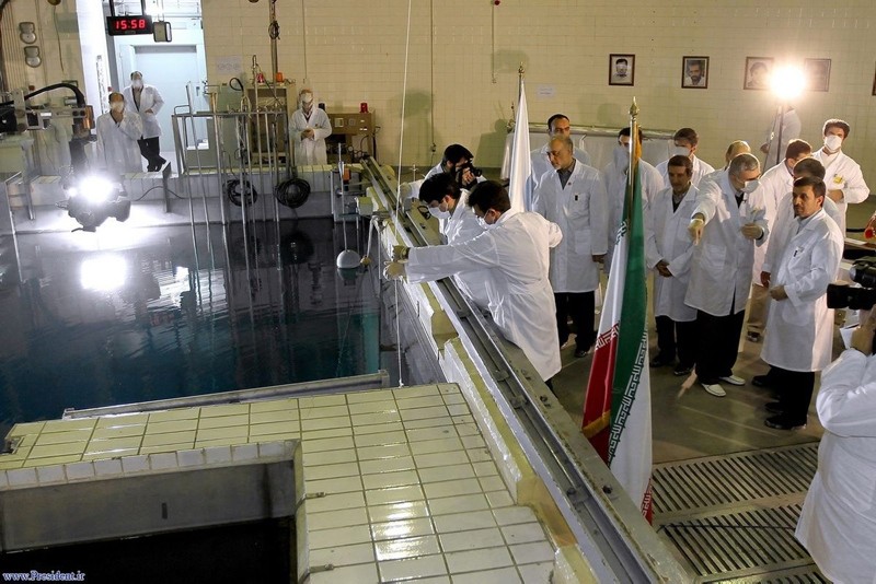 In this Feb. 15, 2012, file photo, provided by the Iranian President's Office, former Iranian President Mahmoud Ahmadinejad, right, is escorted by technicians during a tour of Tehran's research reactor center in northern Tehran, Iran. (AP Photo)