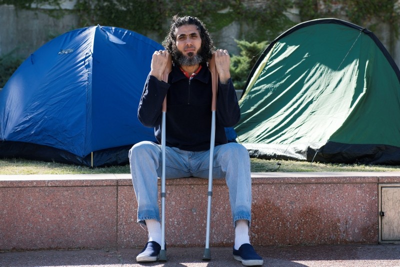 Former Guantanamo detainee Abu Wa'el Dhiab from Syria sits in front of the U.S. embassy while visiting former fellow detainees who were demanding financial assistance from the U.S., in Montevideo, Uruguay. (AP Photo)