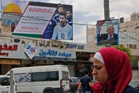 Poster erected on a main street in the West Bank town of Hebron denounces the planned friendly football match between Argentina and Israel and calls Argentina's star Lionel Messi (portrait) to boycott the match.