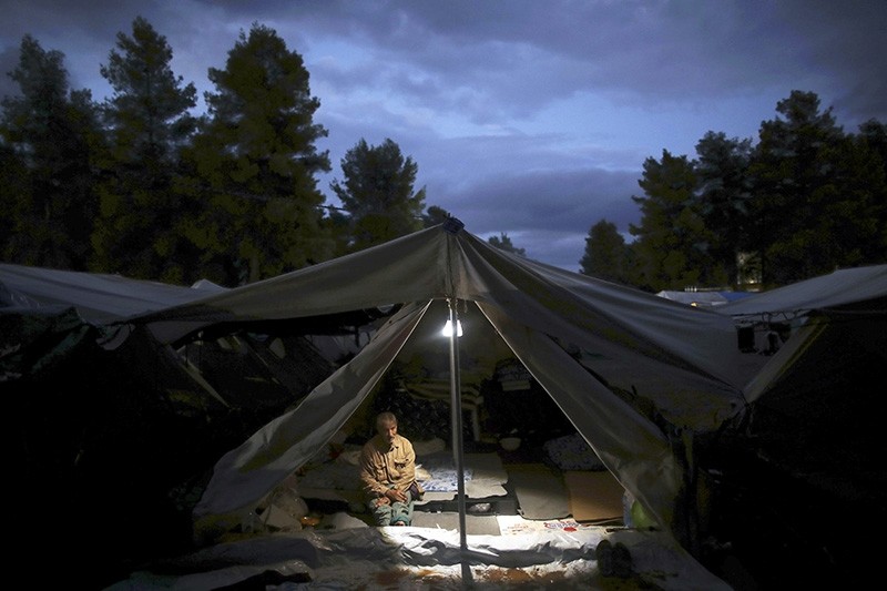 A Syrian man sits inside a tent at the Ritsona refugee camp north of Athens, which hosts about 600 refugees and migrants on Thursday, Sept. 22, 2016. (AP Photo)