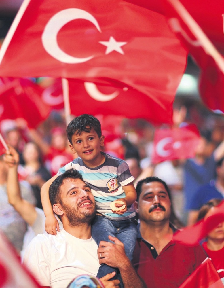 Supporters of President Recep Tayyip Erdou011fan shout slogans against the failed coup attempt as they hold Turkish flags during a demonstration in Taksim Square, Istanbul, July 22, 2016.