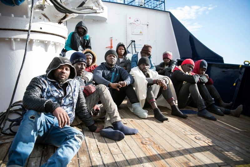 Migrants sit on the deck of the Sea-Eye rescue ship in the Mediterranean Sea, Tuesday, Jan. 8, 2018. (AP Photo)