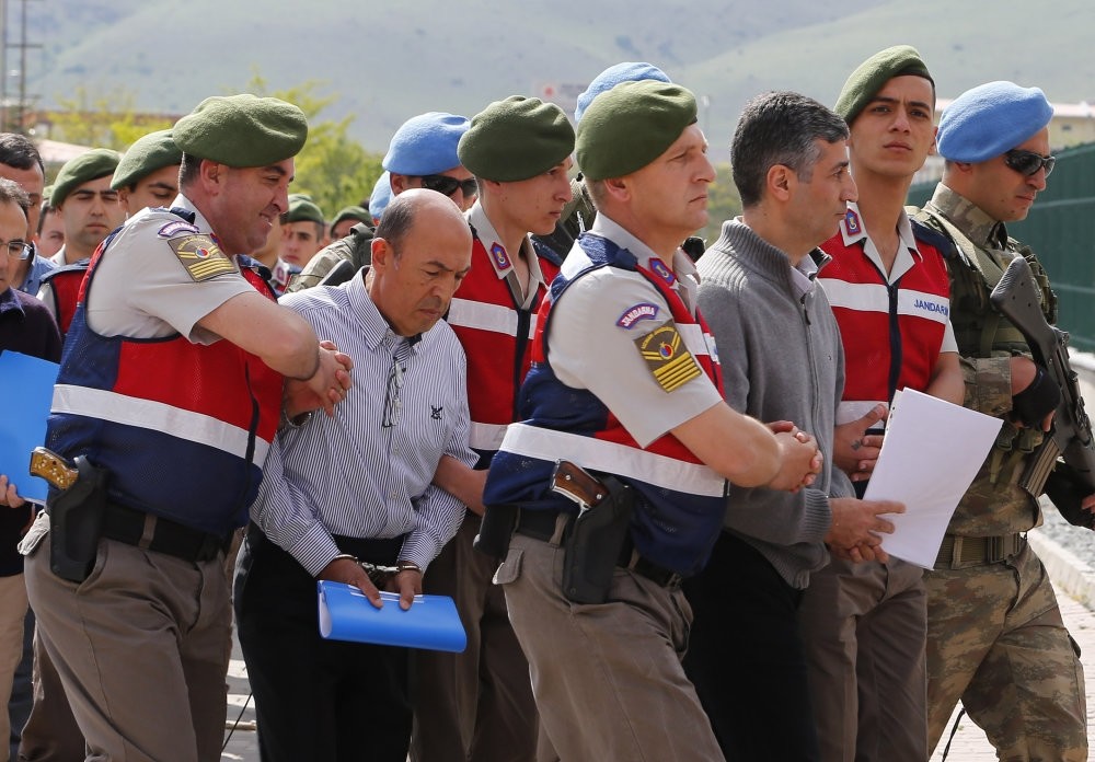 Coup suspects being escorted to the courtroom by gendarmerie troops.