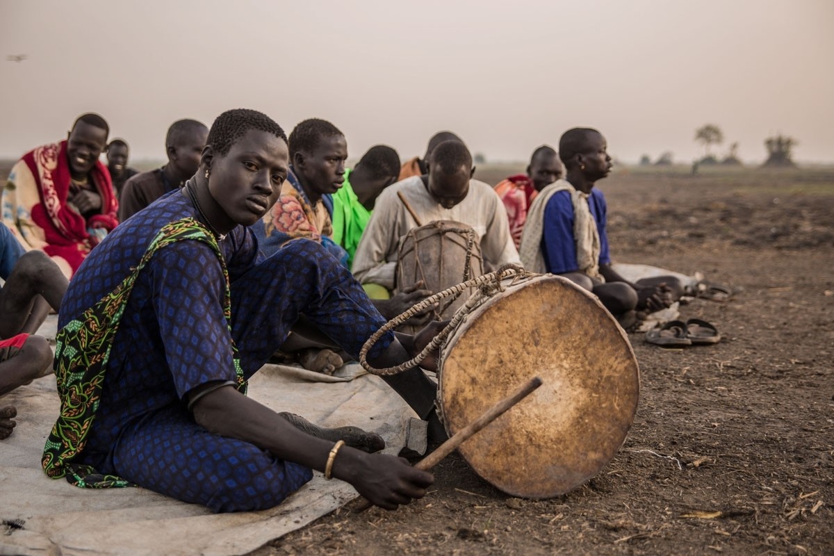 Cattle herders gather for church prayers. The sacrificing of oxen has traditionally been a central component of Dinka religious practice.