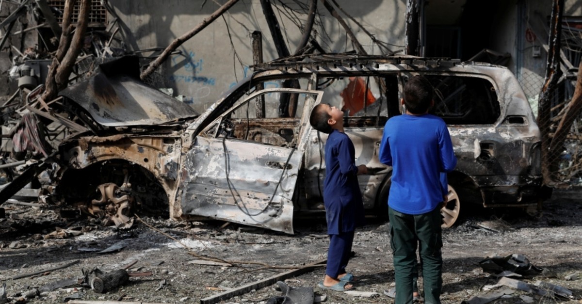 Afghan boys look the site of Sunday's attack in Kabul, Afghanistan July 29, 2019. (Reuters Photo)