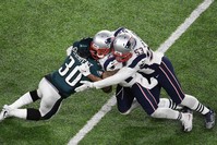 Corey Clement (30) of the Eagles collides with Patrick Chung (23) and Kyle Van Noy (53) of the Patriots during Super Bowl LII between the New England Patriots and the Philadelphia Eagles at U.S. Bank Stadium in Minneapolis.