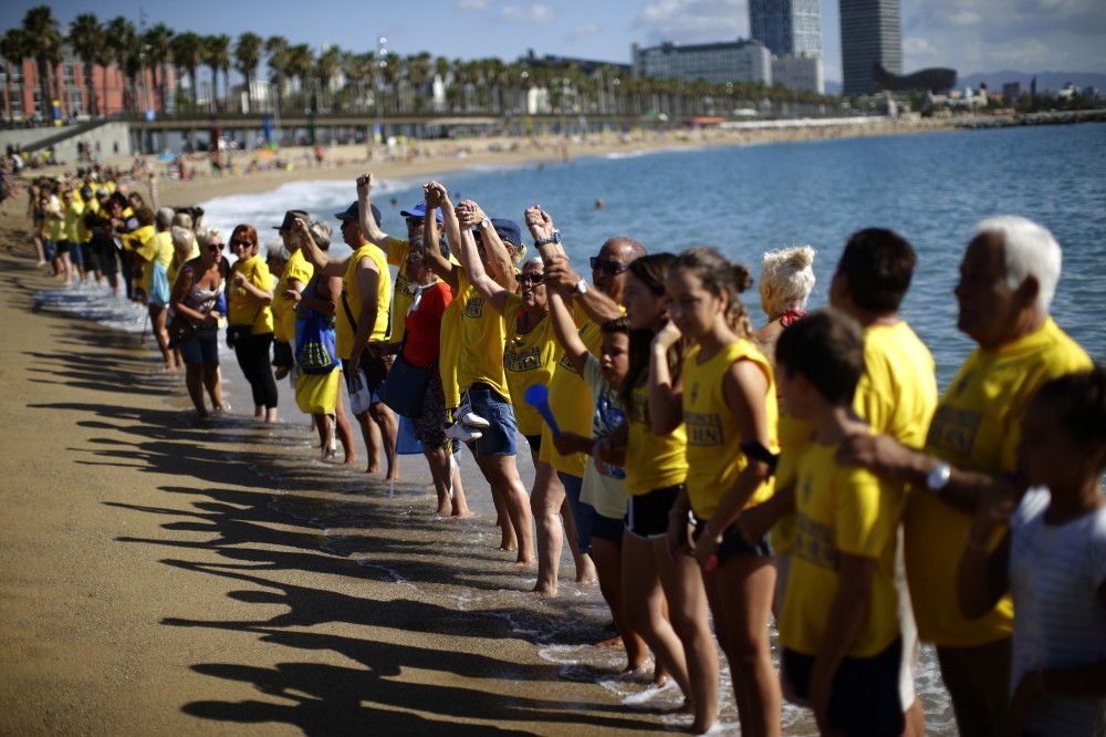 People form a human chain during a protest against tourism in Barcelona. The residents claim that the influx of tourists has increased the price of rents and produced a spike in rowdy behavior by party-seeking foreigners.
