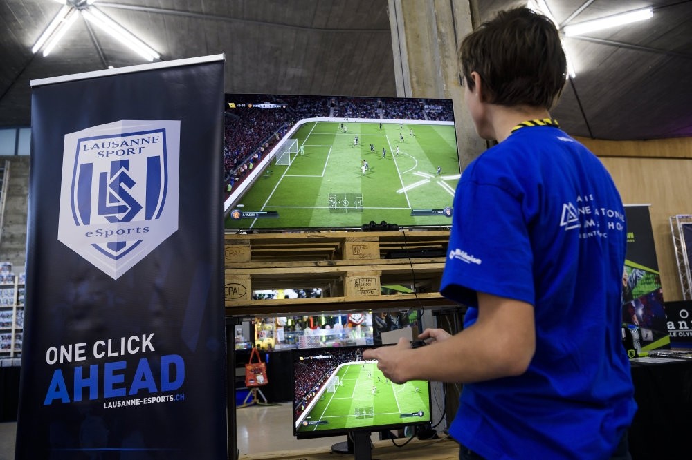 A man plays a virtual football game at the International Gaming Show in Lausanne.