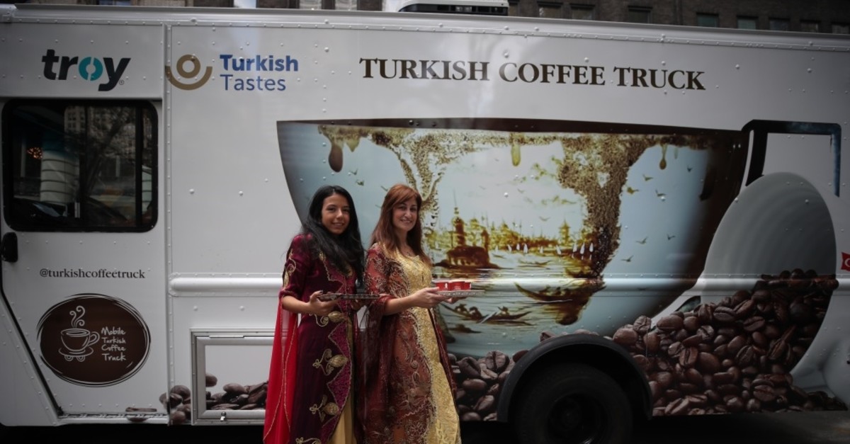 Girls in traditional Turkish attire offer Turkish coffee to New Yorkers.