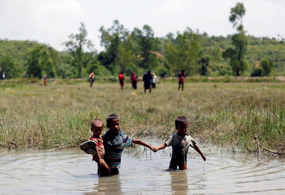 Rohingya children make their way through water as they try to reach the Bangladeshi side from no man's land.
