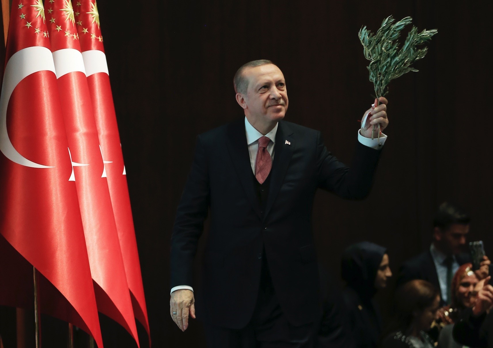 President Erdou011fan holding an olive branch arrives before a speech in the capital Ankara, Feb. 20. 