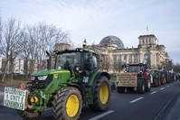 Farmers drive past the Reichstag building with their tractors in Berlin, Saturday, Jan.18, 2020. (AP Photo)