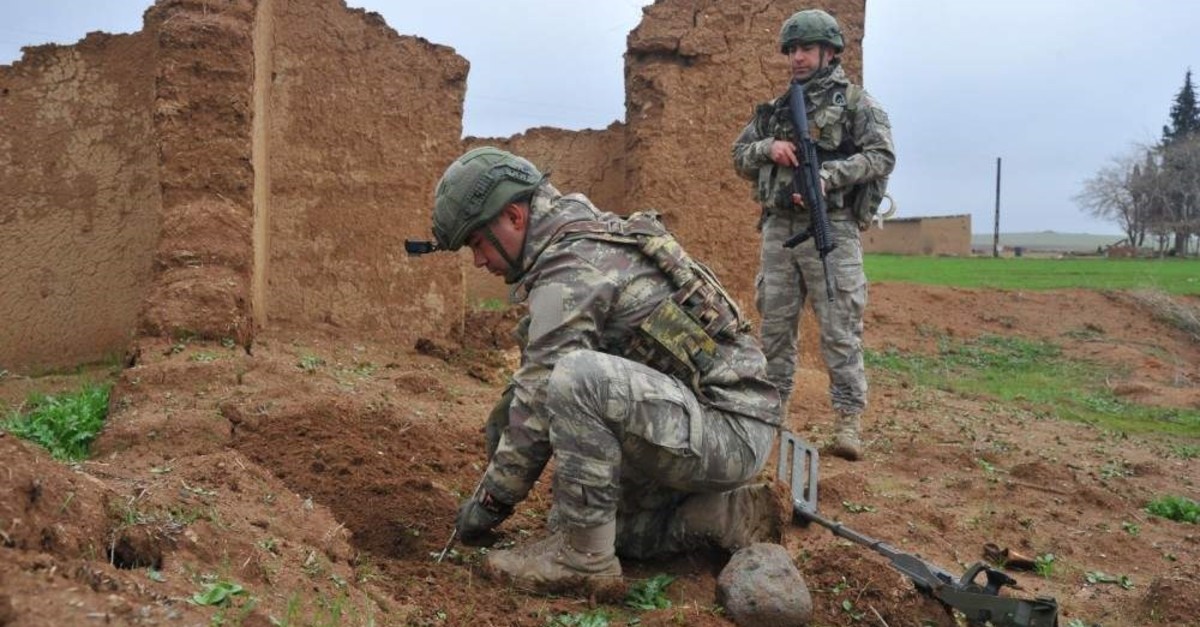 Turkish soldiers clear mines and explosives in northern Syria in this undated handout photo released by the Defense Ministry (Defense Ministry Photo)