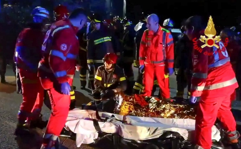 In this frame taken from video rescuers assist injured people outside a nightclub in Corinaldo, central Italy, early Saturday, Dec. 8, 2018. (Vigili del Fuoco via AP)