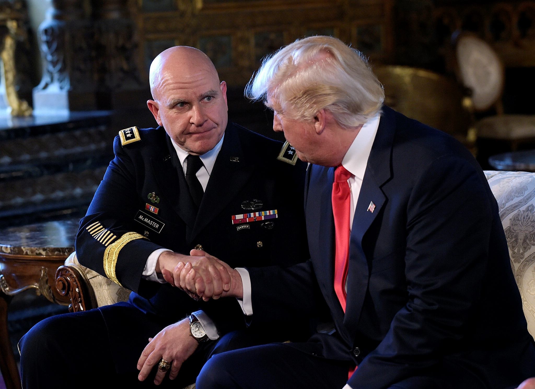 President Donald Trump, right, shakes hands with Army Lt. Gen. H.R. McMaster, left. (AP Photo)