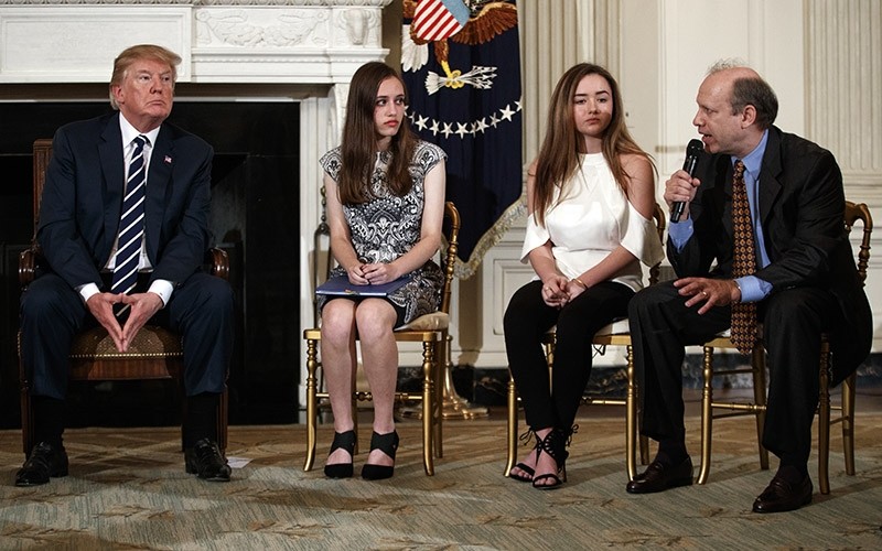 From left, President Donald Trump, Marjory Stoneman Douglas High School student listen as a parent speaks during a listening session with high school students, teachers, and others at the White House in Washington, Feb. 21, 2018. (AP Photo)