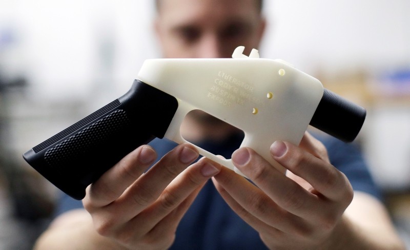 In this Aug. 1, 2018, file photo, Cody Wilson, with Defense Distributed, holds a 3D-printed gun called the Liberator at his shop in Austin, Texas. (AP Photo)