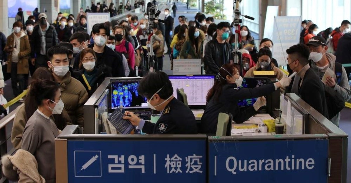 Passengers from China wearing masks undergo fever check upon their arrival at Incheon International Airport, South Korea, Jan. 29, 2020. (Yonhap via Reuters Photo)