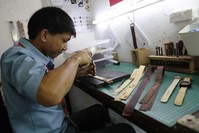 A worker prepares mycelium leather to be used for wristwatches at a workshop in Bandung, Indonesia, Oct. 14, 2019. (REUTERS)