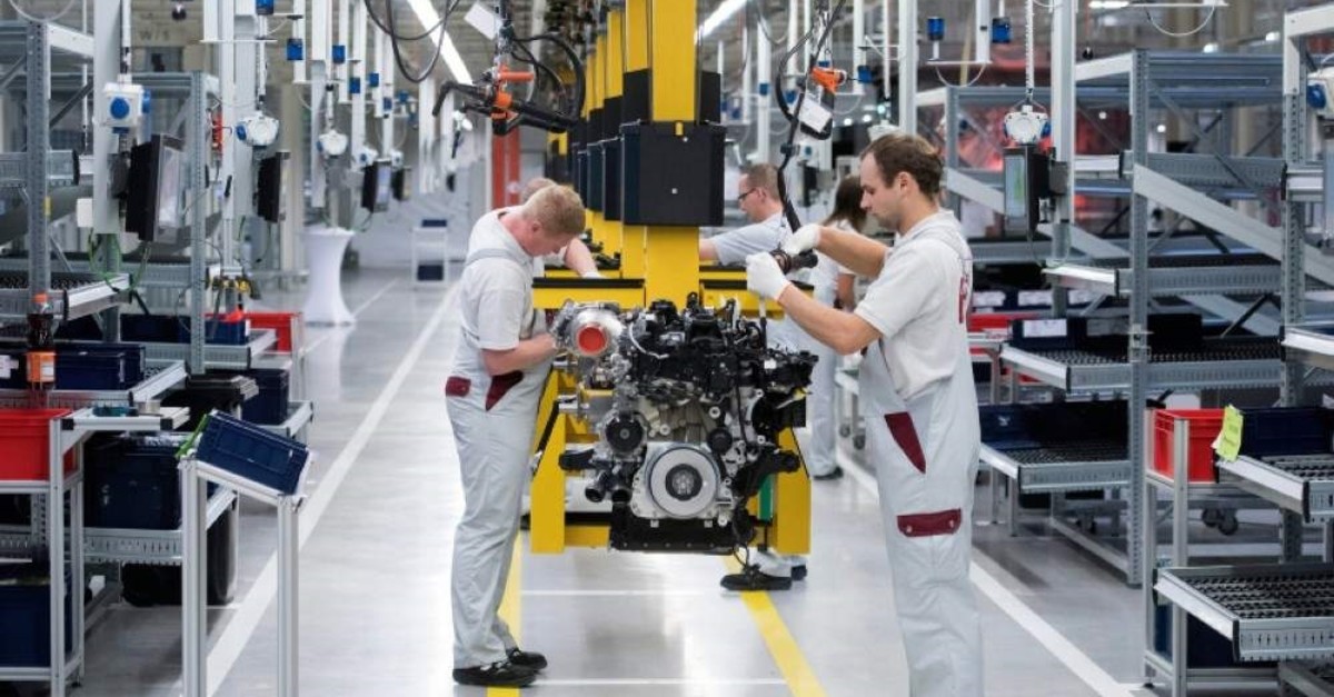 Workers complete the new four-cylinder diesel engine om 654 during the official start of production in the MDC power GMBH, in Koelleda, central Germany, Friday, Oct. 23, 2015. (AP Photo)