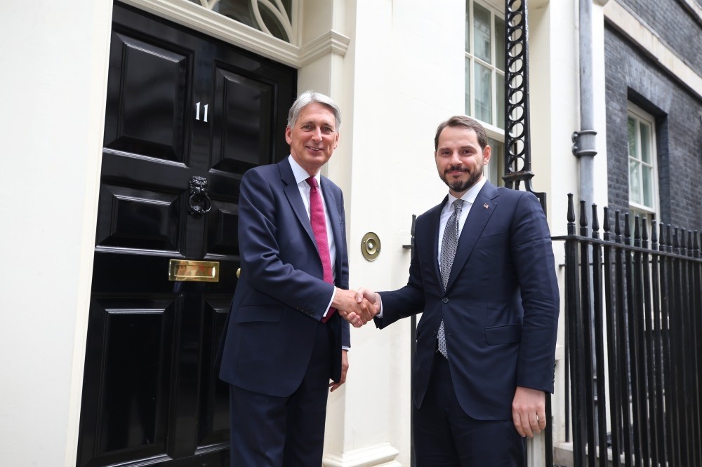 Treasury and Finance Minister Berat Albayrak and his British conterpart Philip Hammond (L) shake hands ahead of their meeting in London, Sept. 3.