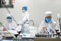 Workers produce face masks to prevent infection of a new virus at a factory in Qingdao, Shandong province, China, Feb. 6, 2020. (AFP Photo)