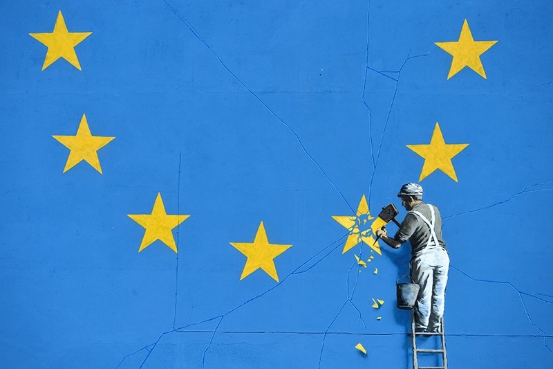 A section of an artwork attributed to street artist Banksy, depicting a workman chipping away at one of the 12 stars on the flag of the European Union, is seen on a wall in the ferry  port of Dover, Britain (Reuters Photo)