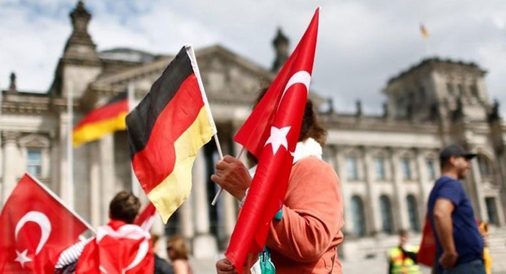 Demonstrator hold Turkish and German flags in front of the Reichstag, the seat of the lower house of parliament in Berlin while protesting against a vote in parliament that recognize the Armenian incidents as u201cgenocideu201d, June 1, 2016.