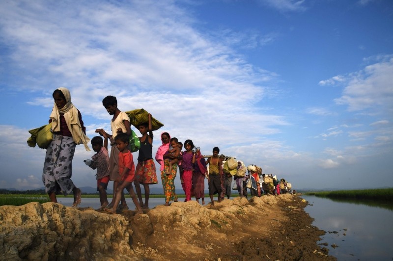 In this file photo taken on November 2, 2017, Rohingya Muslim refugees who were stranded after leaving Myanmar walk towards the Balukhali refugee camp after crossing the border in Bangladesh's Ukhia district. (AFP Photo)