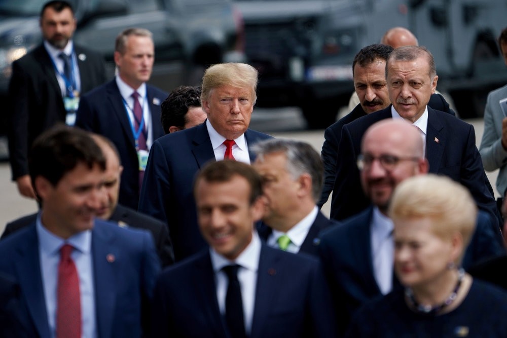President Recep Tayyip Erdou011fan (R) and U.S. President Donald Trump (L) follow other leaders for a photo shoot during the NATO summit in Brussels, July 11.