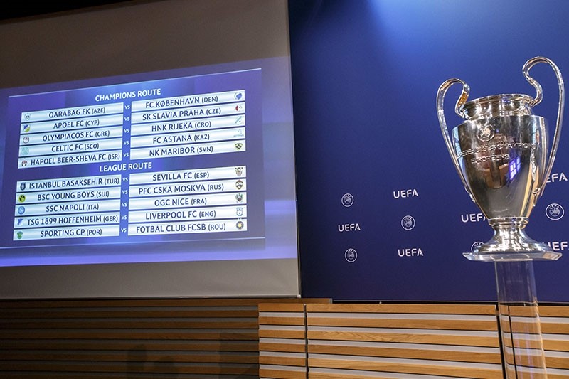 The group formations are shown on an electronic panel next to the Champions League trophy, after the drawing of the games for the Champions League 2017/18 play-off matches at the UEFA headquarters in Nyon, Switzerland, Aug. 4, 2017. (AP Photo)