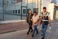 Police escort a suspect captured in an operation in the southern city of Adana, Sept. 13, 2019.