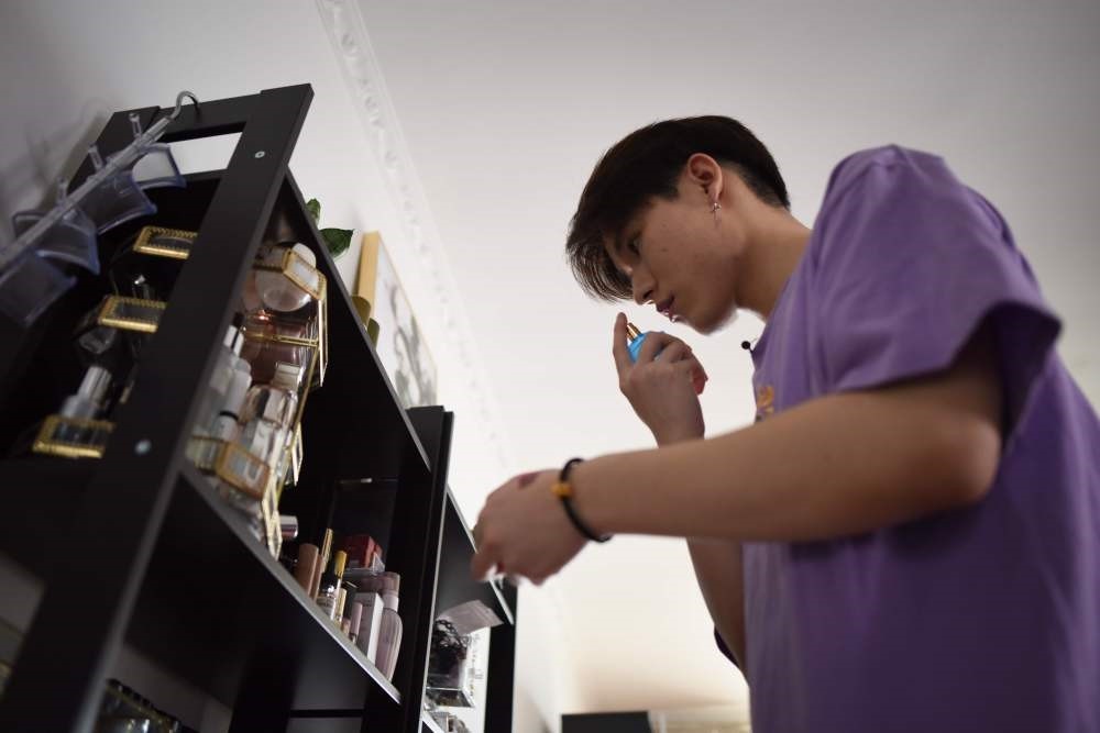 Jiang Cheng selects perfume at his home in Beijing. Jiang Cheng is among hundreds of Chinese men sharing beauty tips online and cashing in on the booming male cosmetics industry.
