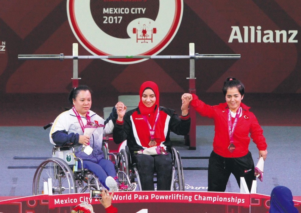 Thi Lihn Phuong Dang (L) of Vietnam, Rehab Ahmed of Egypt and Besra Duman (R) of Turkey pose with their medals during the Paralympic Weightlifting Championships.