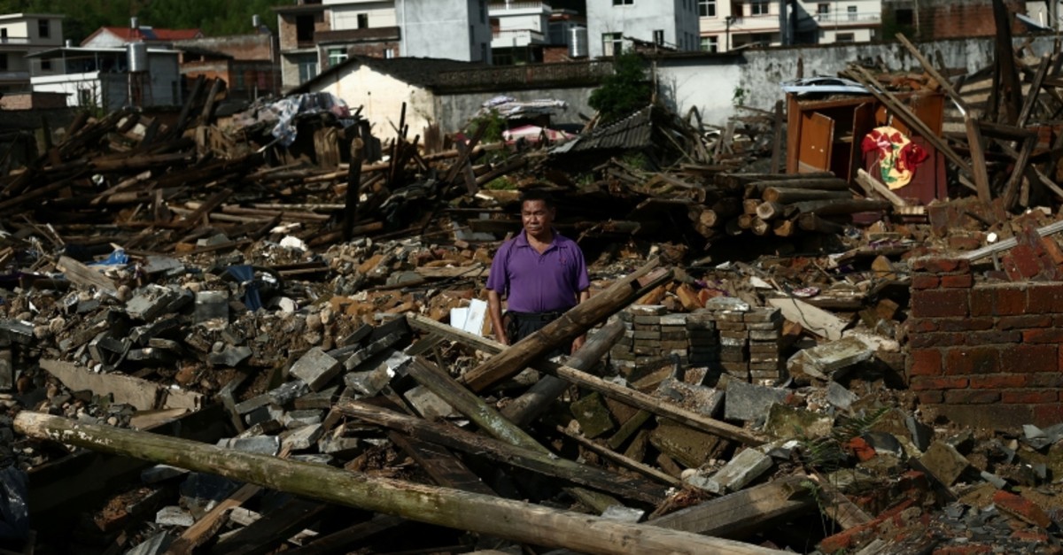 A villager stands on the debris of his house damaged by flood following heavy rainfall in Qingliu county, Sanming, Fujian province, China June 3, 2019. (Reuters Photo)