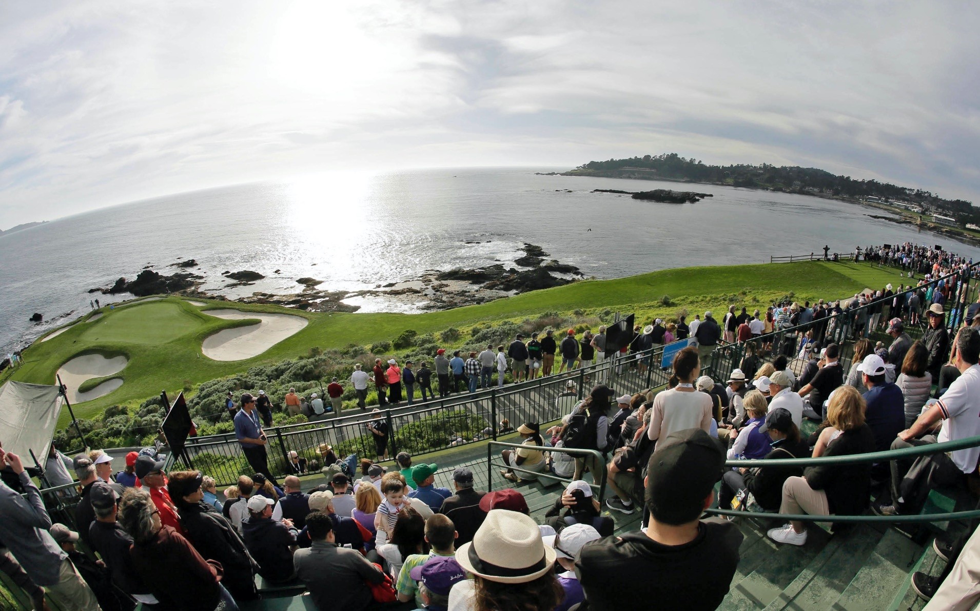 Fans line the seventh hole of the Pebble Beach Golf Links to watch the inaugural $1 million celebrity hole-in-one event of the AT&T Pebble Beach National Pro-Am golf tournament in Pebble Beach, Calif.