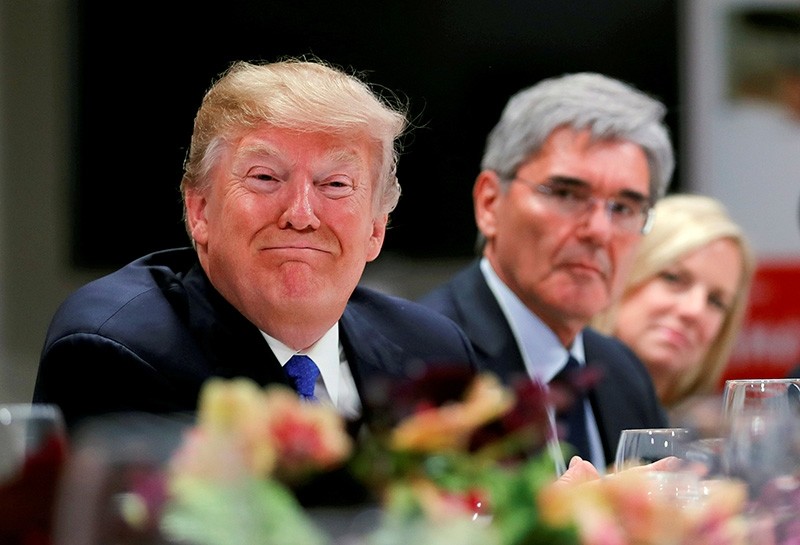 U.S. President Donald Trump attends a dinner with business men and CEO's during the World Economic Forum (WEF) annual meeting in Davos, Switzerland January 25, 2018. Siemens CEO's Joe Kaeser (C) looks on. (Reuters Photo)