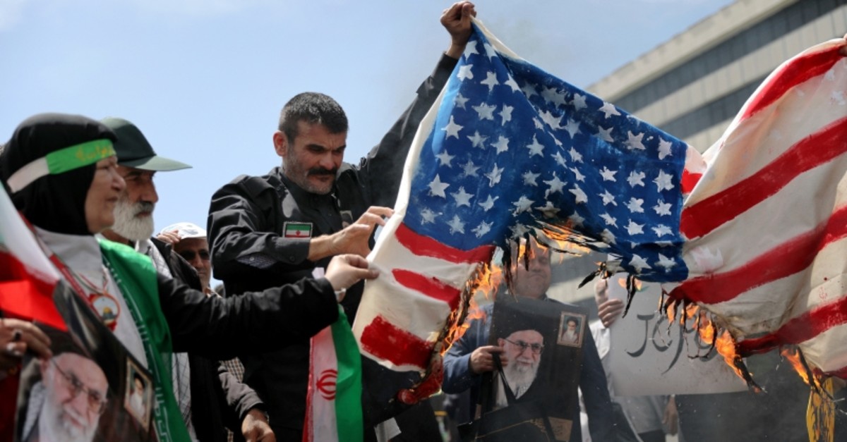Iranian worshippers burn a representation of a U.S. flag during a rally after Friday prayer in Tehran, Iran, Friday, May 10, 2019. (AP Photo)