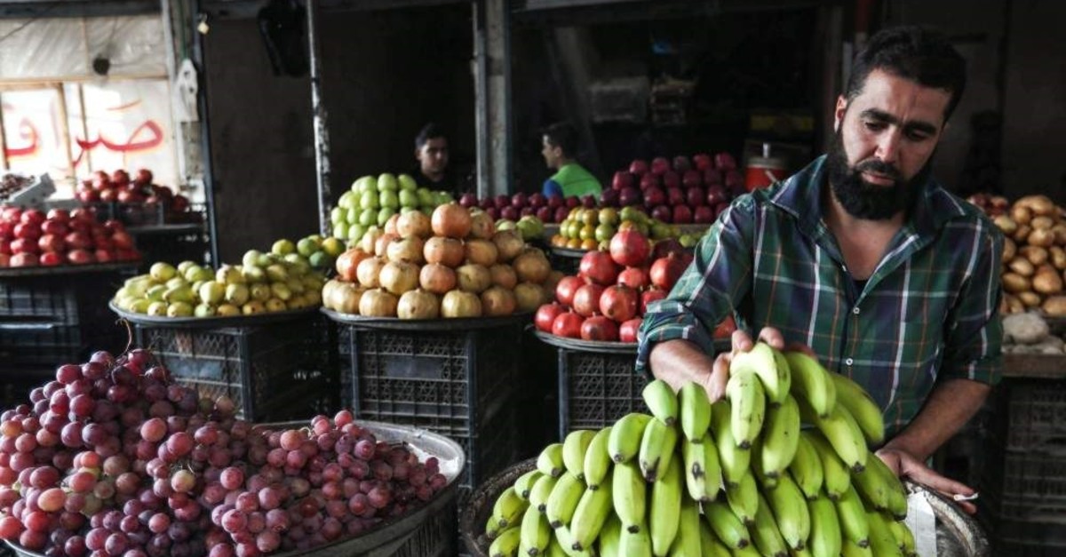A SYRIAN FRUIT MERCHANT ORGANISES BANANAS OUTSIDE HIS SHOP IN THE REBEL-HELD TOWN OF MAARET AL-NUMAN, IN THE NORTH OF IDLIB PROVINCE ON SEPTEMBER 27, 2018. (Photo by OMAR HAJ KADOUR / AFP)