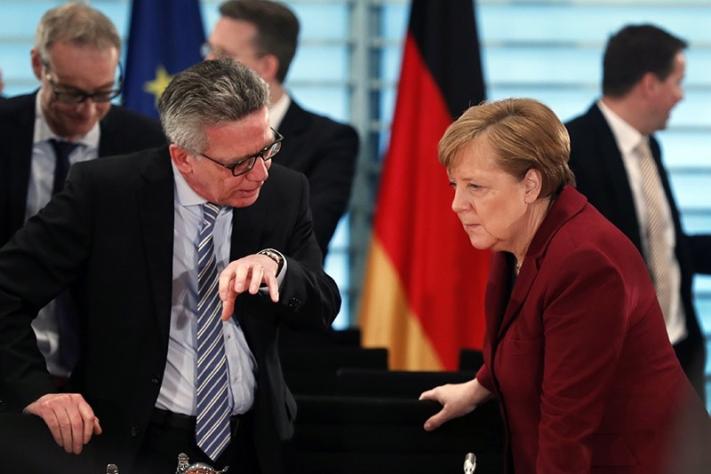 German Chancellor Angela Merkel (R) listens to the Minister of the Interior, Thomas de Maiziere (L) at the beginning of a meeting in Berlin, Germany, 05 April 2017. (EPA Photo)