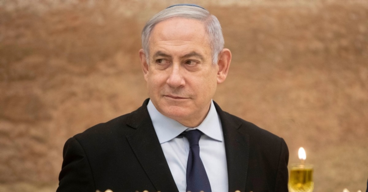 Israeli Prime Minister Benjamin Netanyahu looks on after lighting a Hanukkah candle at the Western Wall, the holiest site where Jews can pray in Jerusalem's old city, December 22, 2019. (Reuters Photo)